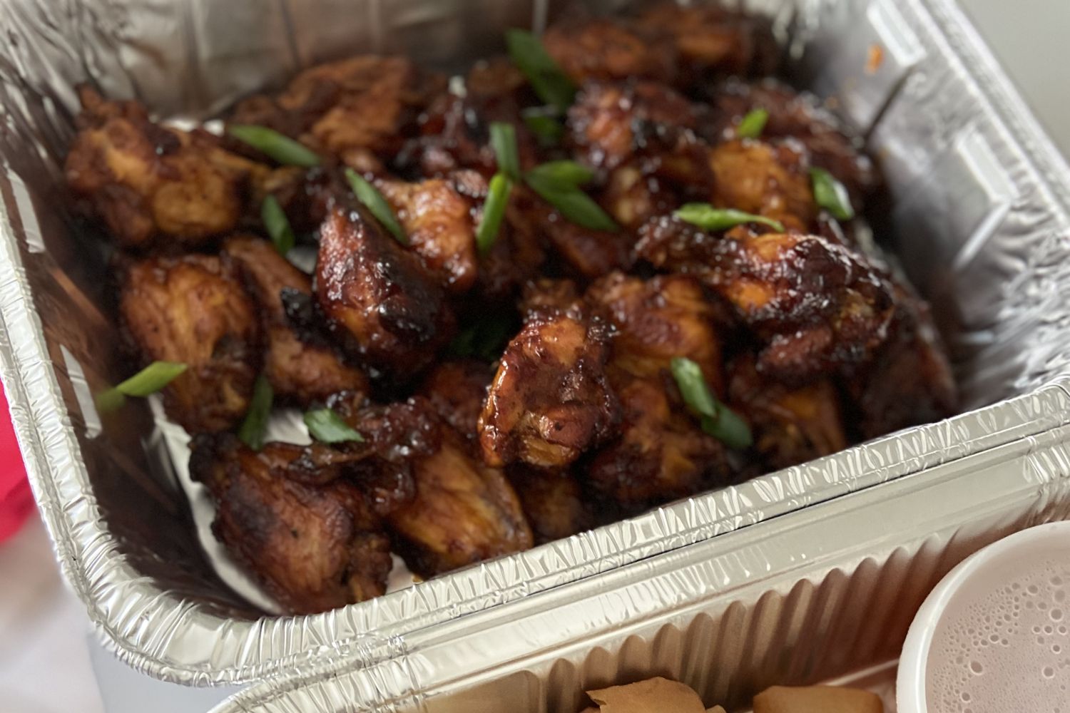 Glossy, saucy chicken wings finished with fresh spring onion
